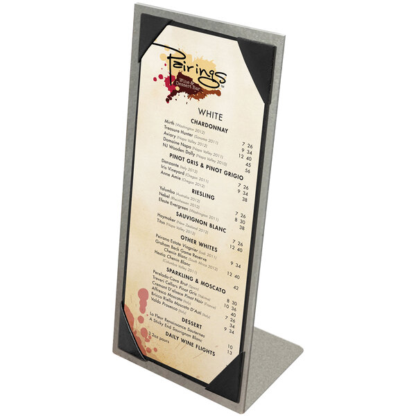 A brushed aluminum Menu Solutions table tent with picture corners holding a menu on a stand.