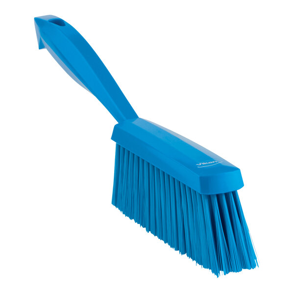 A blue Vikan hand brush with a long handle.