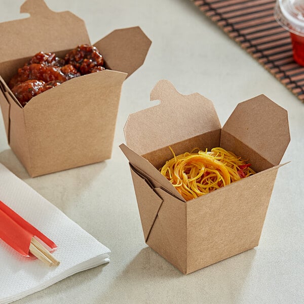 An Emperor's Select Chinese take-out container filled with noodles and meatballs on a white background.