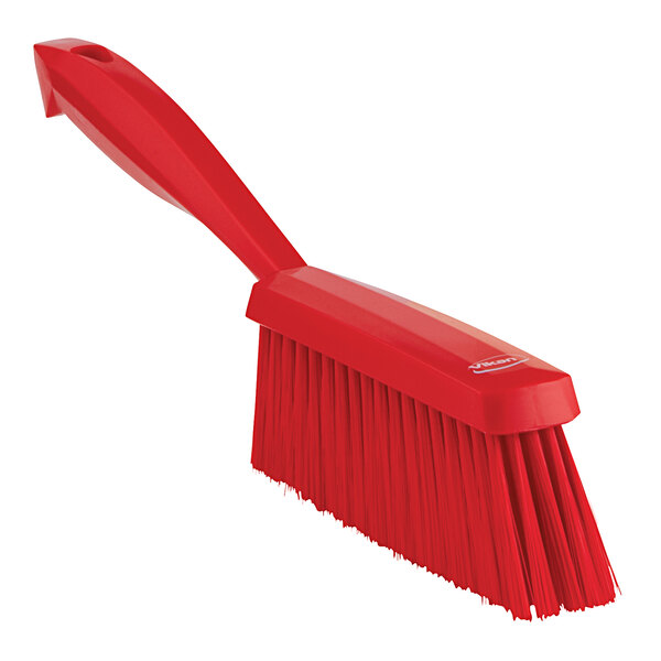 A red brush with a long handle.