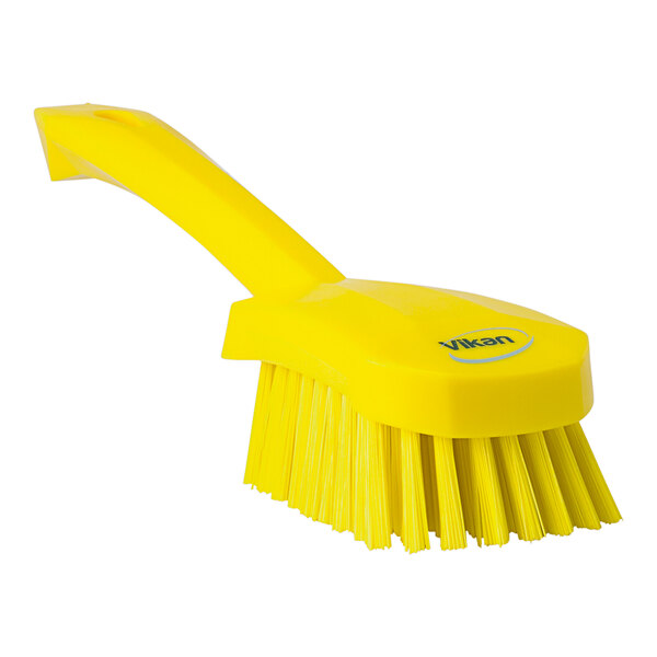 A yellow Vikan washing brush with a handle.