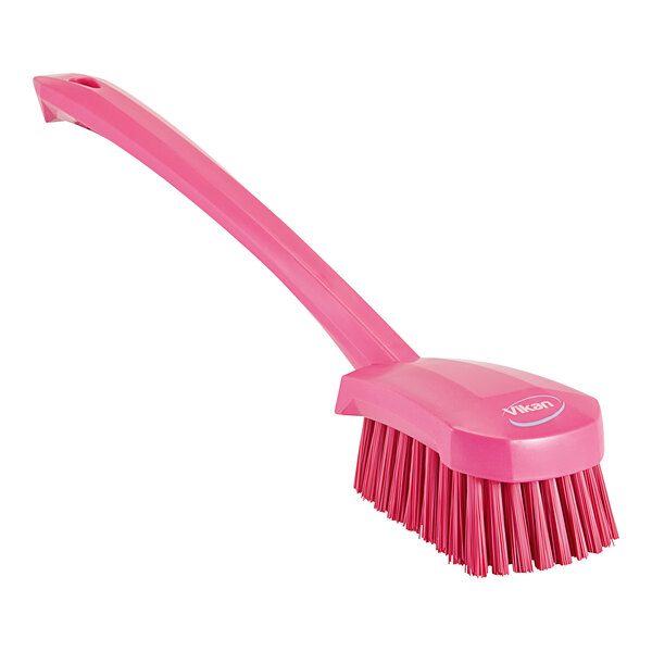 A pink Vikan washing brush with a long handle.