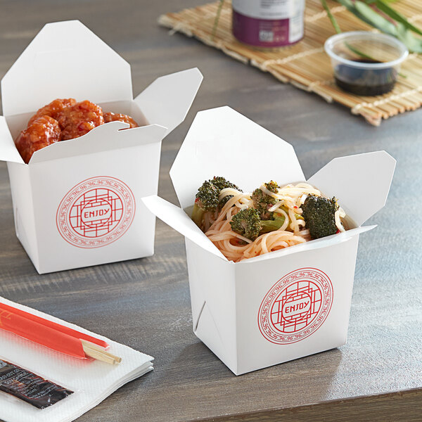 Two Emperor's Select Asian microwavable take-out containers with food in them.
