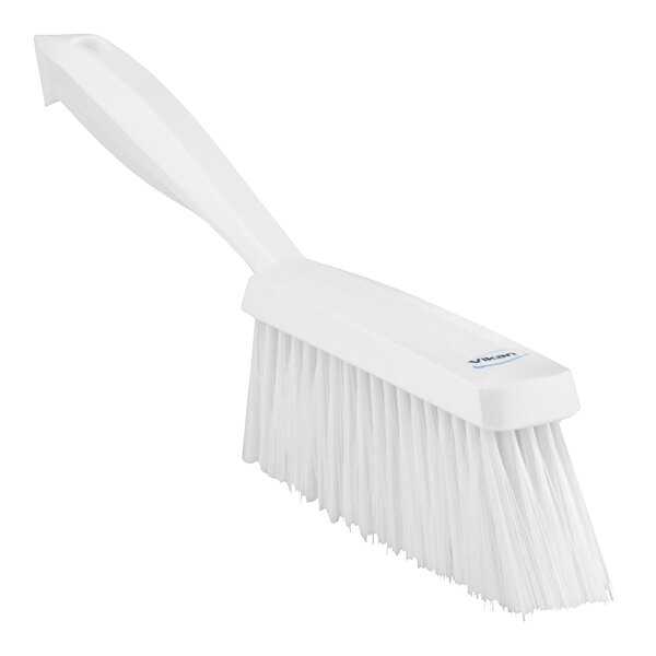 A white brush with a handle.