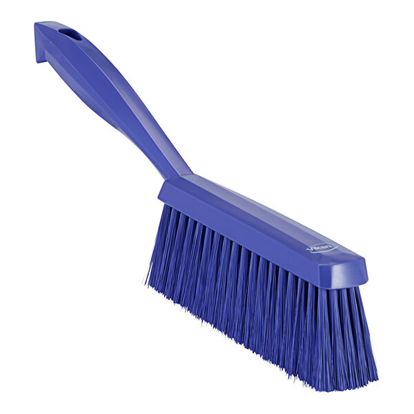 A purple hand brush with a long handle.