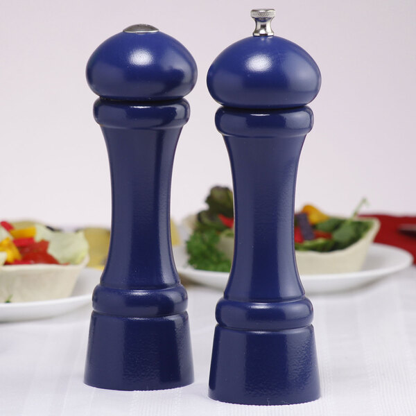Two cobalt blue salt and pepper shakers on a table.