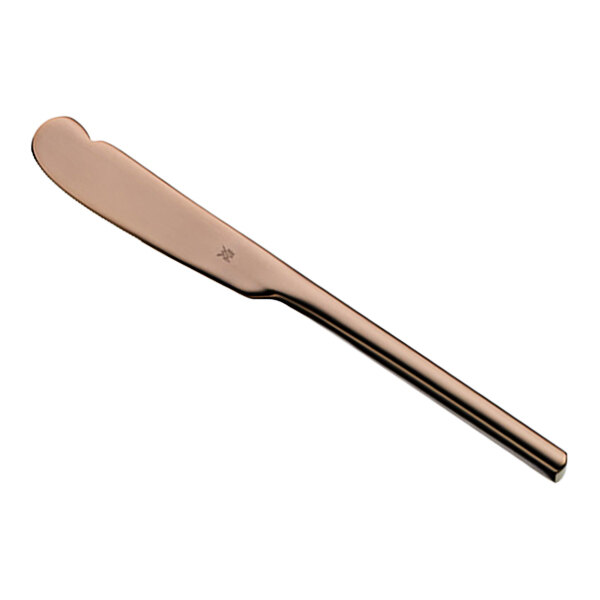 A close-up of a WMF Unic copper standing butter knife with a rose gold handle.