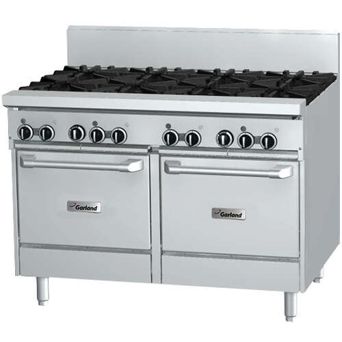 A large stainless steel Garland commercial range with black knobs, two burners, and two white ovens.