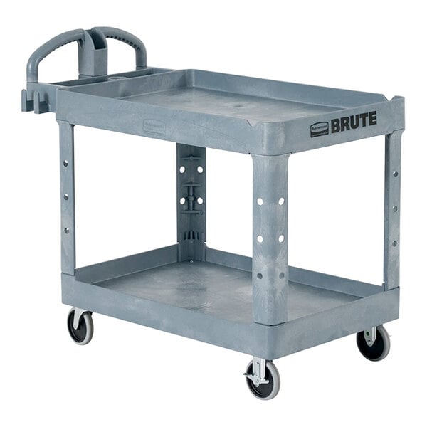 A grey Rubbermaid Brute 2-tier plastic utility cart with wheels.