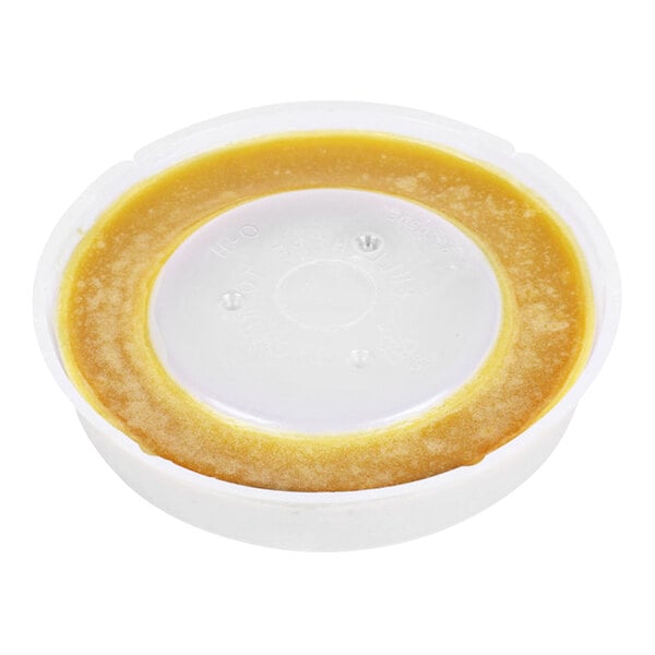 A white plastic container with a white lid containing yellow wax.