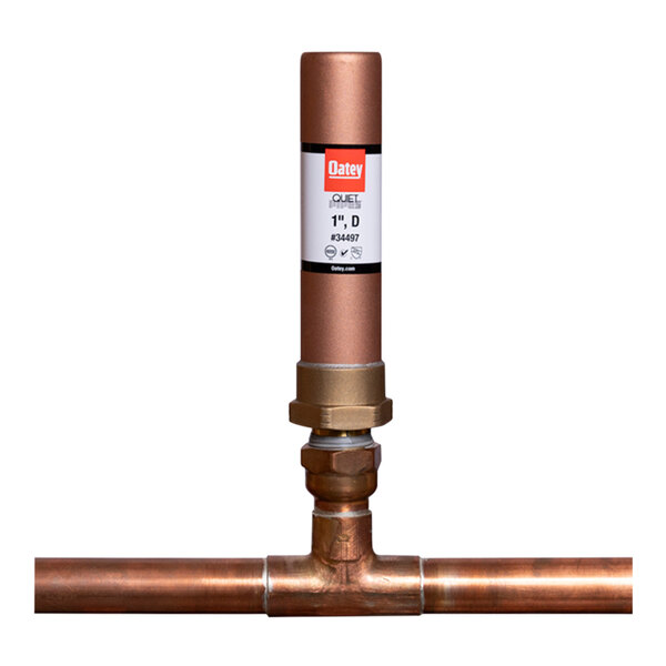 A copper pipe with a white label on an Oatey Quiet Pipes D Straight Hammer Arrestor.