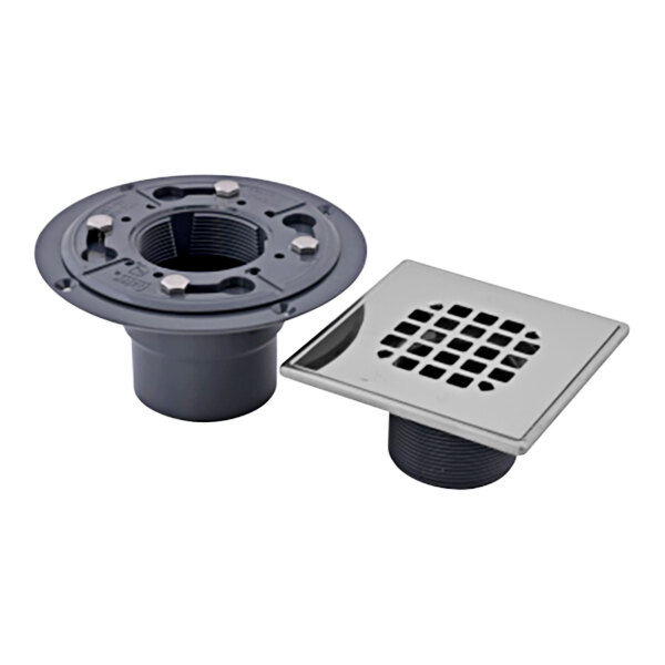An Oatey PVC shower drain with a stainless steel snap-in strainer over a grey drain.
