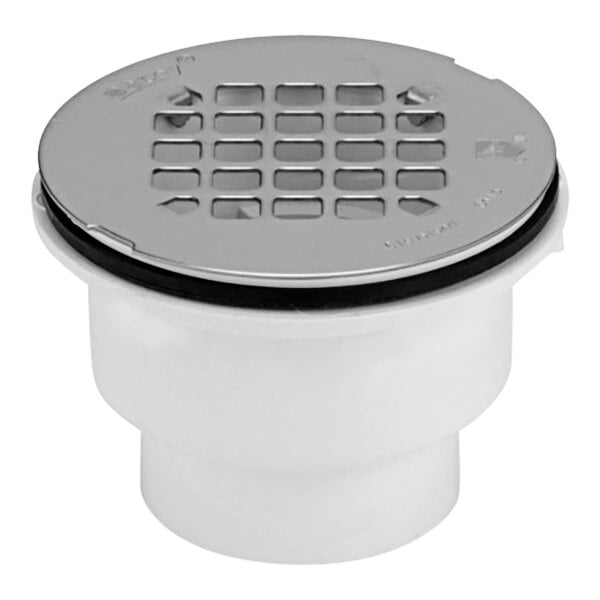 A white Oatey shower drain with a silver round grid.
