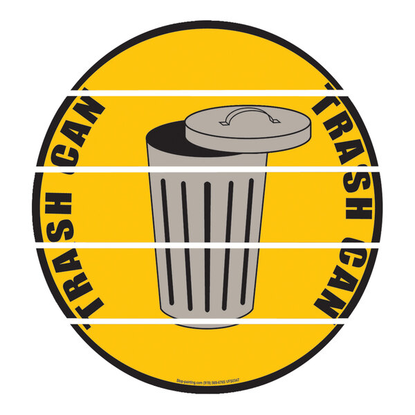 A yellow and black circular floor sign with a trash can image.