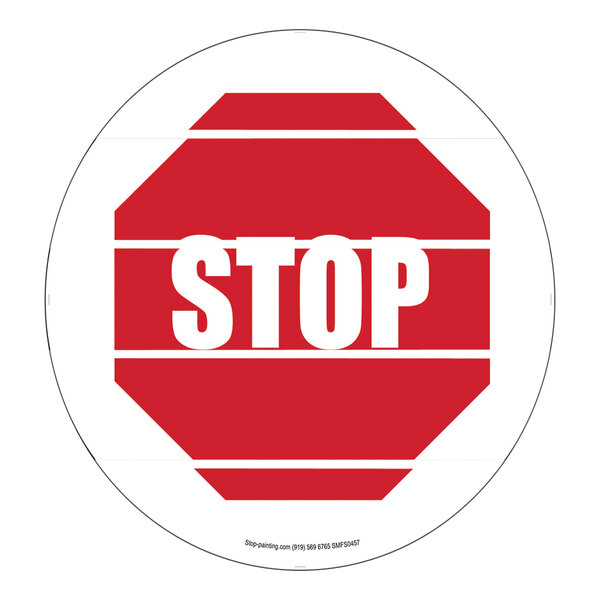 A red and white Superior Mark "Stop" safety floor sign.