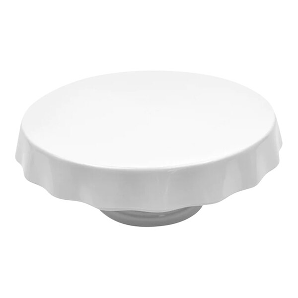 A white melamine round cake stand with a white rim.