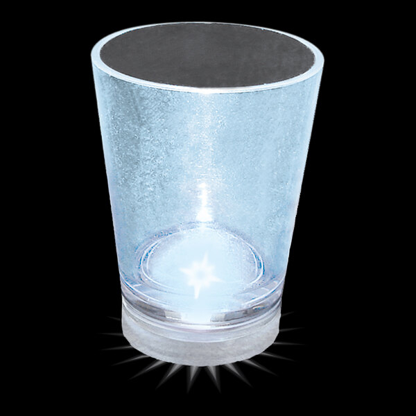 A clear plastic shot cup with a white LED light on it.
