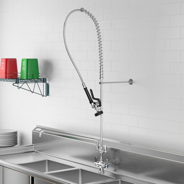 A stainless steel sink with a Regency pre-rinse faucet and an add-on faucet hose.