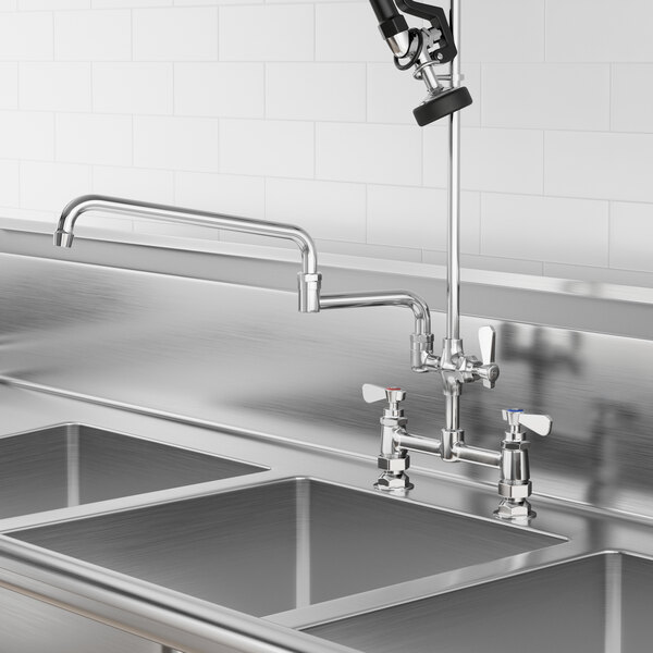 A Regency add-on faucet with double-jointed swing spout installed on a professional kitchen sink.