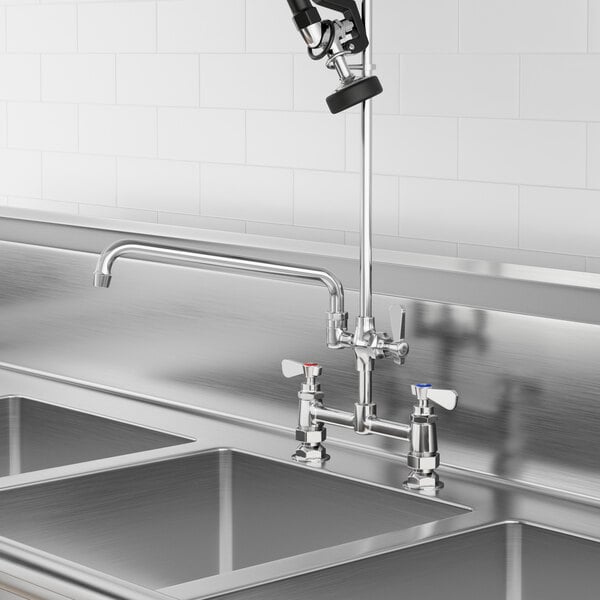 A stainless steel sink with a Regency pre-rinse add-on faucet and 12" swing spout.