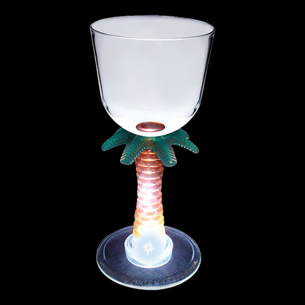 A clear plastic wine cup with a palm tree stem and a white LED light.