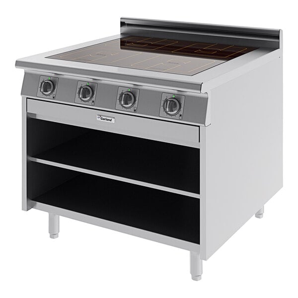 A stainless steel Garland Master Series electric range with induction burners and storage.