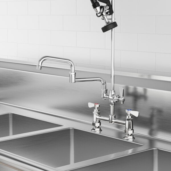 A Regency Pre-Rinse Add-On Faucet with double-jointed swing spout above a sink in a professional kitchen.