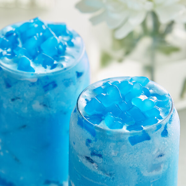 Two glasses of blue drinks with Fanale Blueberry Heart-Shaped Jelly Topping and ice cubes.