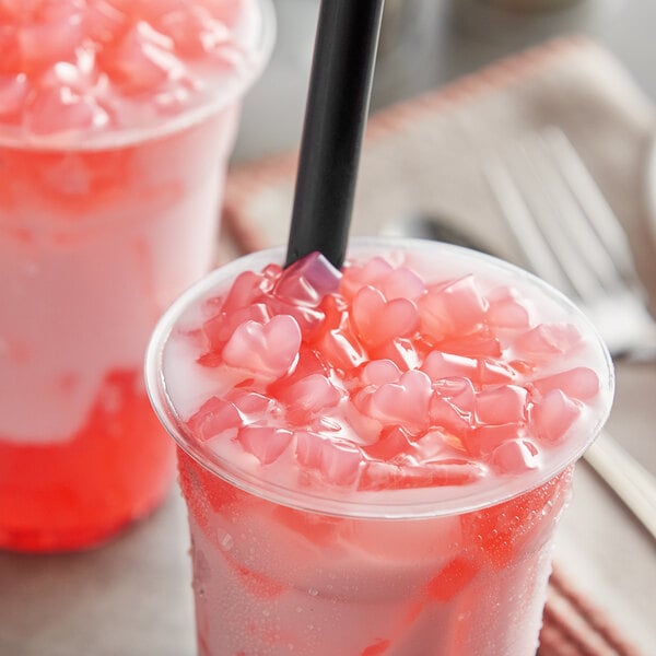 A cup of pink liquid with Fanale Sakura Cherry Blossom Heart-Shaped Jelly.