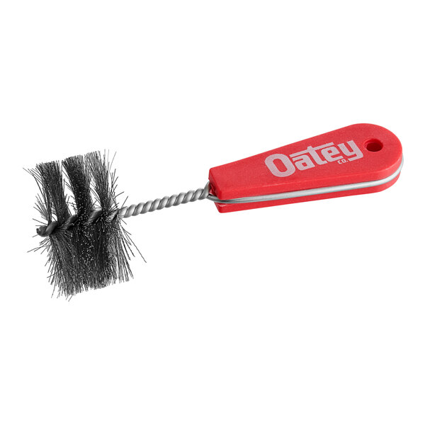 A close-up of an Oatey 2" Fitting Brush with a metal handle.