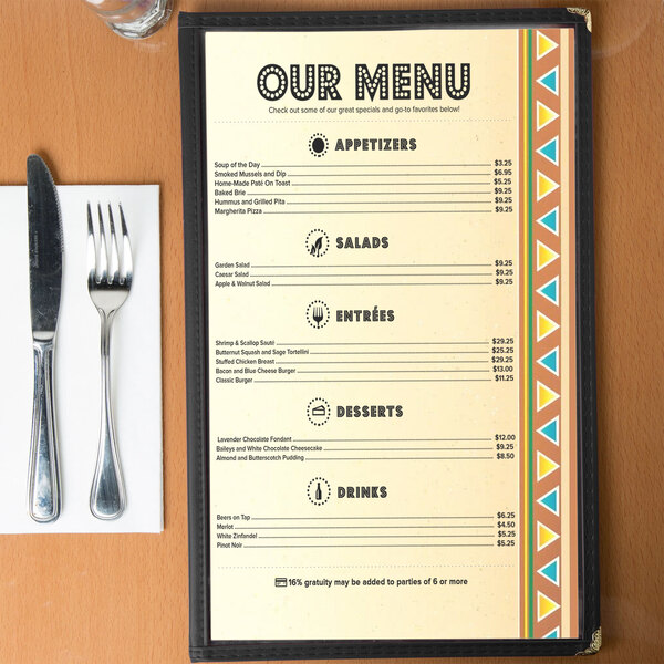 Menu paper with a Southwest fiesta border design on a table with a fork and knife.