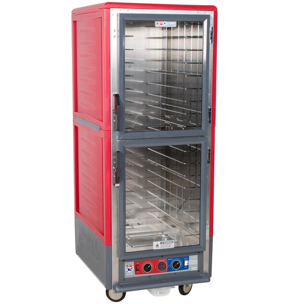 A red and silver Metro C5 heated holding and proofing cabinet with clear Dutch doors.
