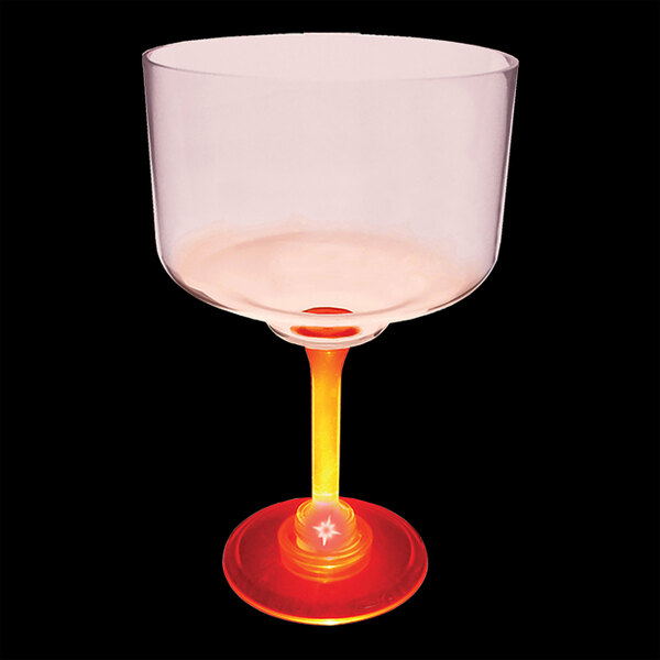 A clear plastic margarita cup with a red and yellow base.