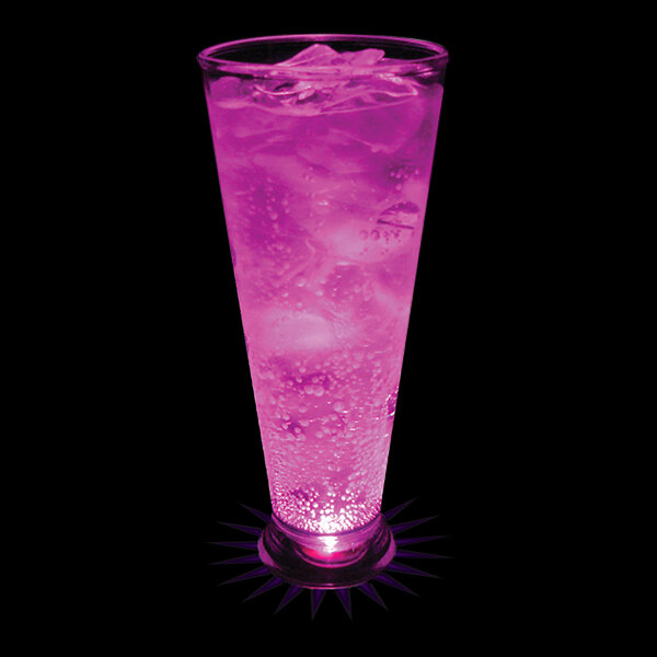 A 16 oz. plastic pilsner cup with a pink drink and ice in it, with a purple LED light shining on it.