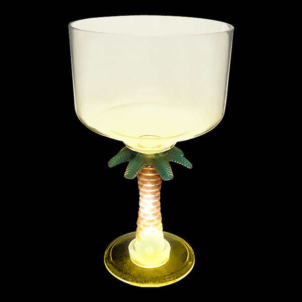 A clear plastic margarita glass with a palm tree stem.