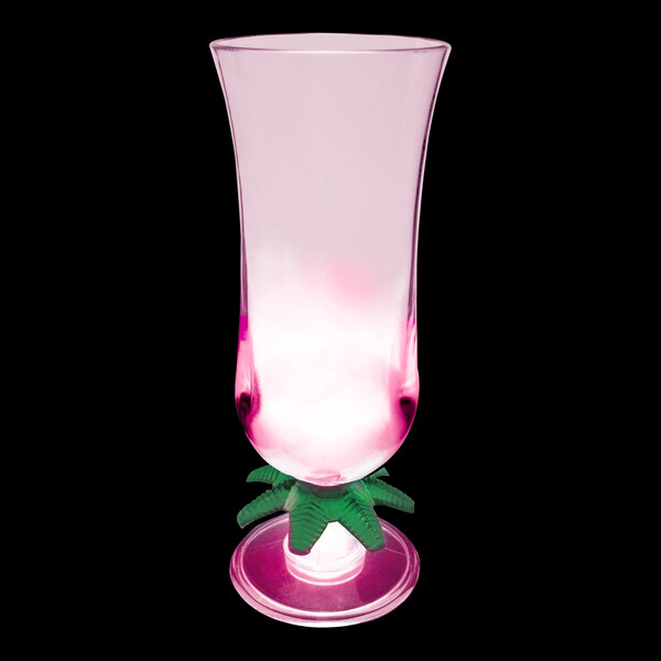 A close-up of a customizable plastic palm tree hurricane cup with a pink LED light.