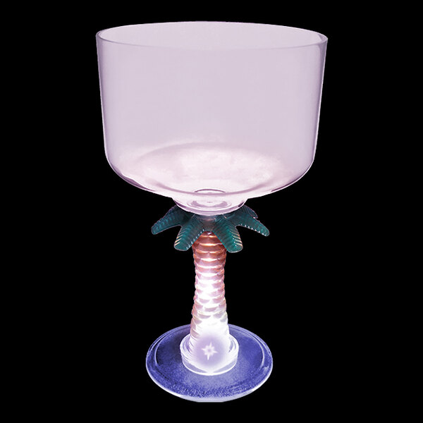 A clear plastic margarita cup with a colorful palm tree stem.
