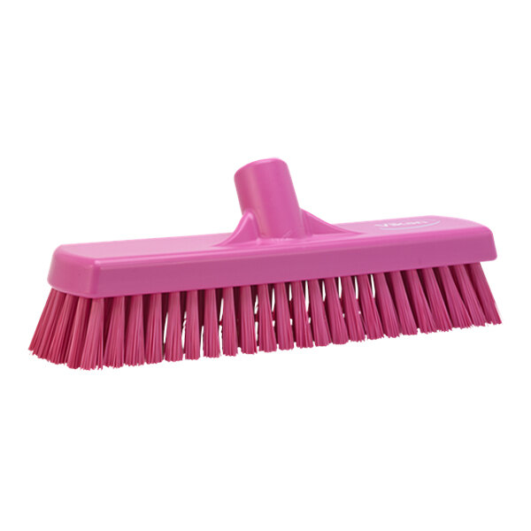 A Vikan pink brush head with stiff bristles.