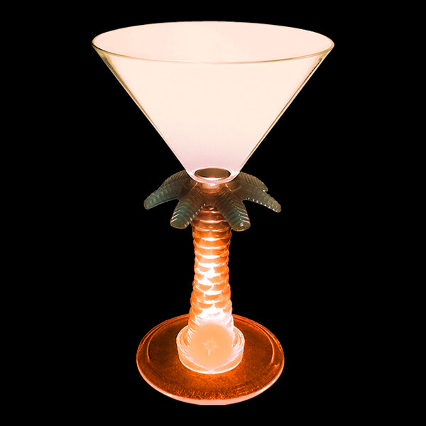 A close-up of a customizable plastic martini glass with a palm tree stem and an orange LED light inside.