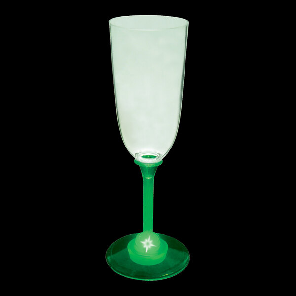 A close-up of a customizable plastic champagne cup with a green LED light on it.