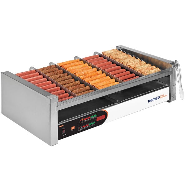 A Nemco digital slanted hot dog roller grill with hot dogs cooking.