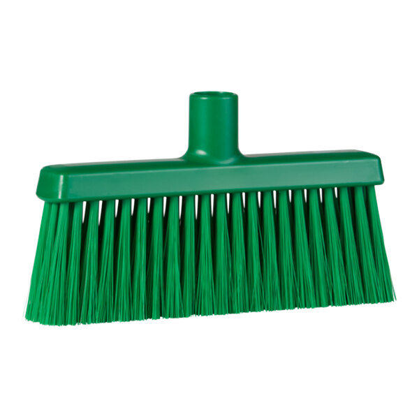 A green broom head with long bristles.