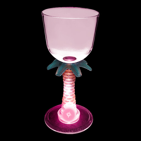 A clear plastic wine cup with a palm tree stem and pink LED light.