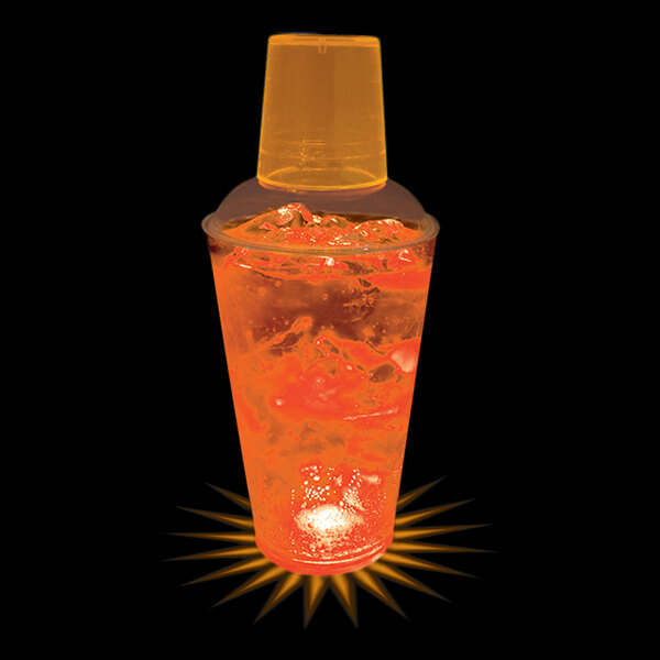A close-up of a plastic shaker with orange LED lights and a drink inside.