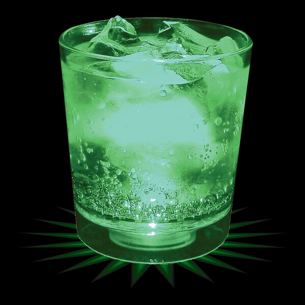 A customizable plastic rocks cup with a green LED light filled with ice and a green liquid.