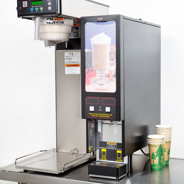 A Bunn Fresh Mix cappuccino machine on a table with cups.