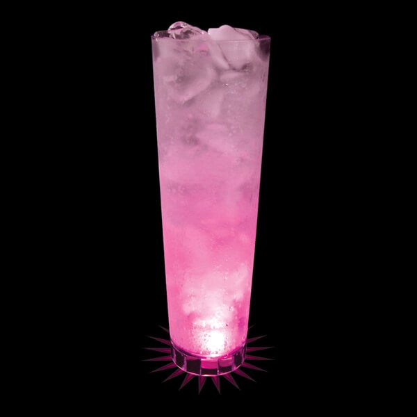 A 32 oz. plastic cup with a pink LED light filled with a pink drink and ice.