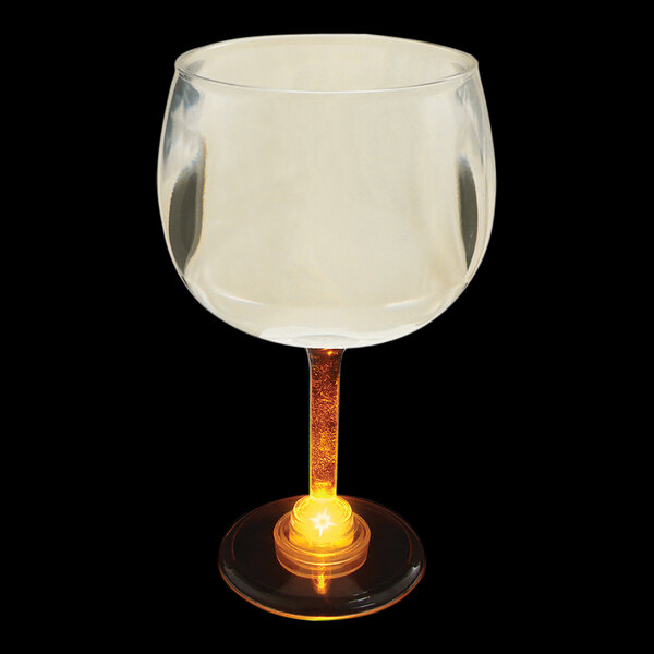 A customizable plastic goblet with a yellow LED light inside of it.