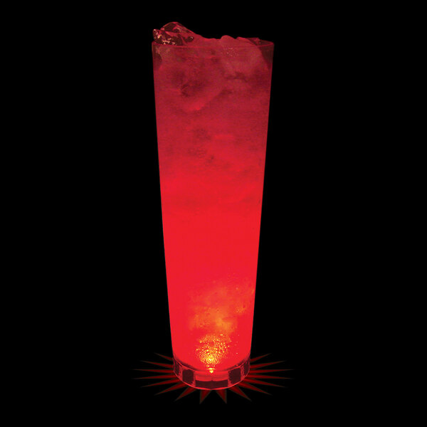 A 32 oz clear plastic cup with a red LED light inside filled with water on a table with a red and black background.