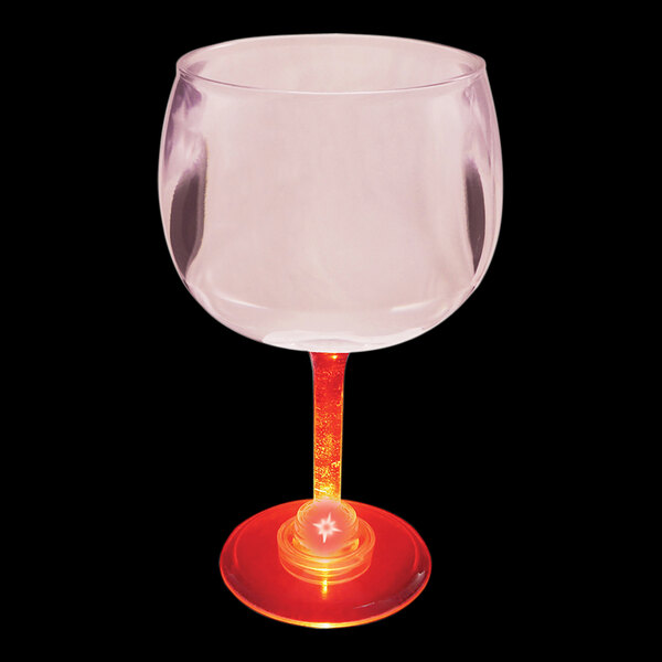 A close up of a customizable plastic goblet with a red LED light on the base.